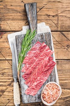 Premium Rare Slices of Wagyu A5 beef with high marbled texture. wooden background. Top view