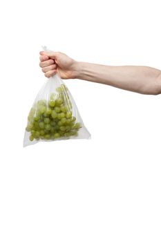 polythene bag held in hand isolated on white. man holding packet of fresh grape
