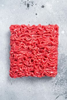 Raw Mince Ground meat on a butcher table. Gray background. Top view