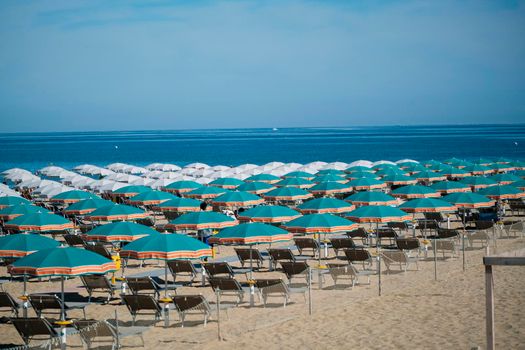umbrellas open on the seafront of Riccione on the Romagna Riviera