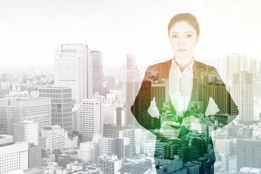 double exposure of business woman buttoning suit with city background
