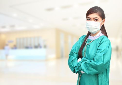female doctor wearing a green scrubs and stethoscope in hospital