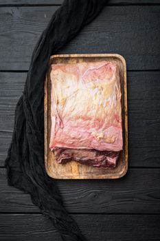 Sirloin steak, uncooked beef meat, on black wooden background, top view