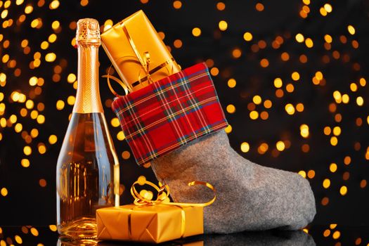 Champagne bottle and Christmas stocking with gifts
