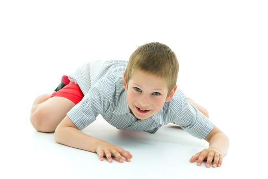 A little boy is crawling on the floor. The concept of children's