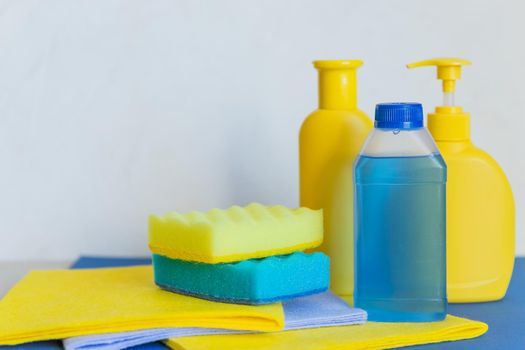 various sponge.Plastic bottles with cleaning products and sponge on a two-color background. Varioucontainers for household chemicals.White plastic containers for household detergents, home chemistry.
