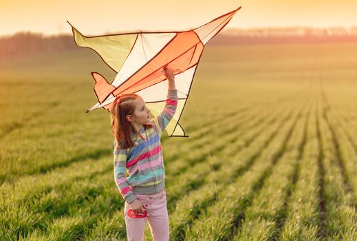 Little girl with flying kite