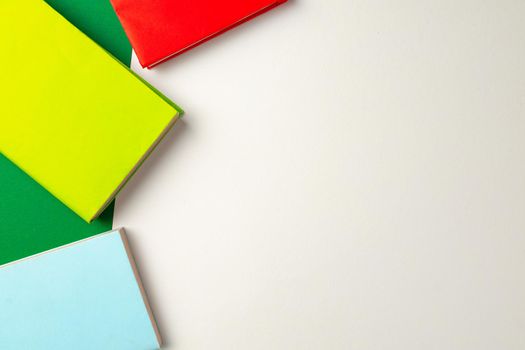 Three colorful notepads on desk top view