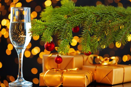 Champagne glass on blurred garland lights background