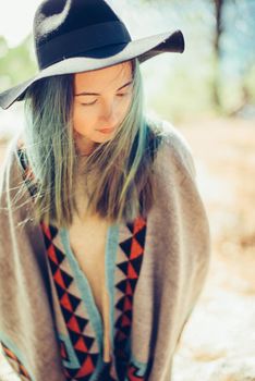 Beautiful woman in hat and poncho