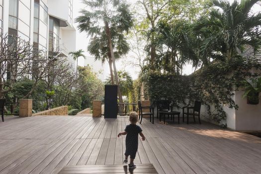 Little boy running on hotel terrace