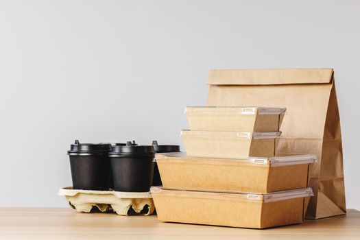 Many various take-out food containers, pizza box, coffee cups and paper bags on light grey background