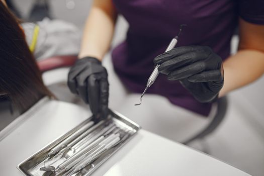 Tools in a hands. Dentist holds instruments