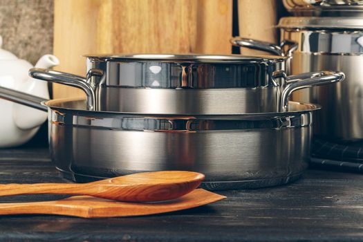 Set of stainless steel saucepans in a kitchen
