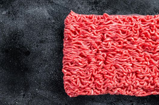 Raw mince beef meat on a kitchen table. Black background. Top view