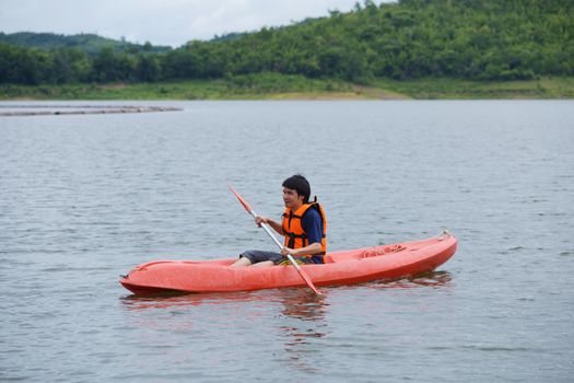 Man paddling in a kayak boat in Thailand