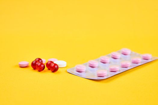 pill packaging vitamins antibiotics pharmaceutical yellow background