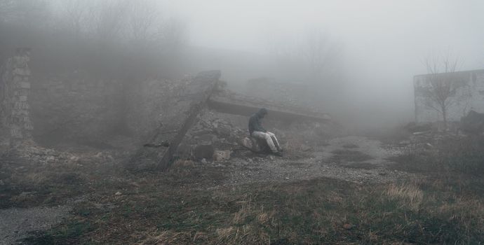 Man sitting among the ruins