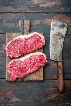 Veiny steak, marbled beef meat, on dark wooden background, top view