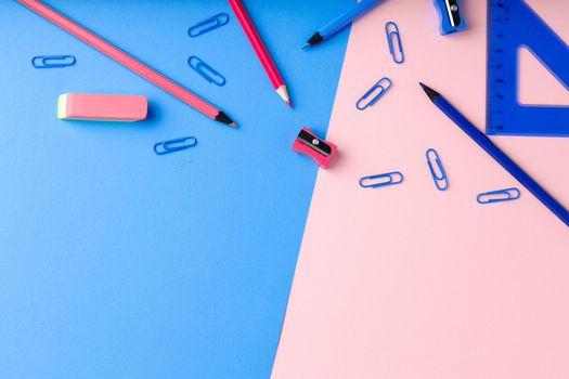 Back to school. Scattered stationery on paper background