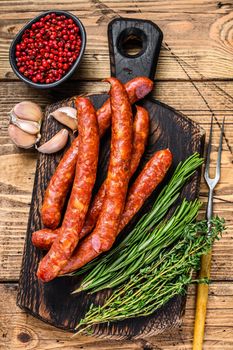Pork Smoked sausages with addition of fresh aromatic herbs and spices. wooden background. Top view