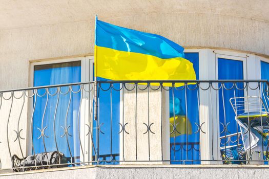 National flag of Ukraine on the hotel balcony. Patriotism concept