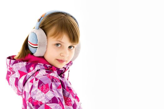 A little girl with headphones listening to music.