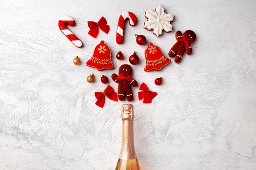Golden champagne bottle with Christmas gingerbread flatlay
