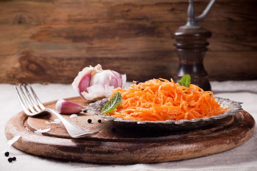 Spicy Korean style carrot salad on metal plate