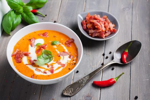 Carrot sweet pepper cream soup with bacon