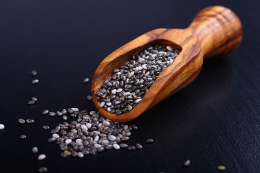 Chia seeds in wooden scoops, one of the superfoods