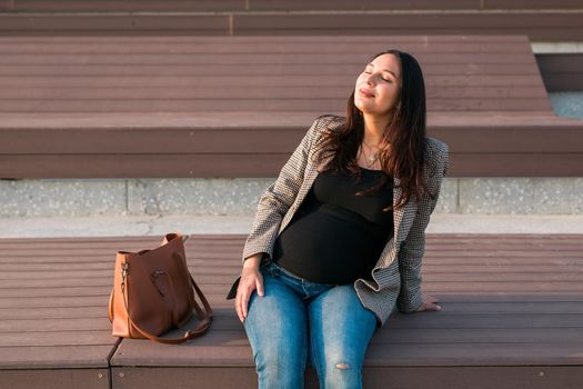 Urban portrait of a modern pregnant latina woman. Pregnancy and parenthood concept.