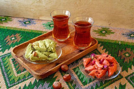 Turkish sweet baklava on metal tray with Turkish tea