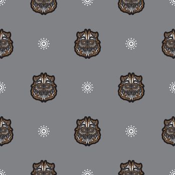 Seamless pattern with tiger head in simple boho style. Good for clothing, textiles and prints. Vector illustration.