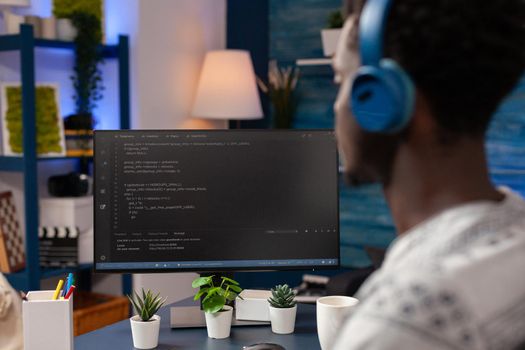 African american young developer wearing headset while typing security codes