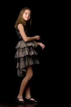 Beautiful young teen girl studio photo on black background