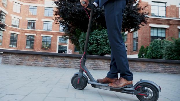 Executive manager riding electric scooter moving forward along startup company