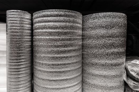 Silver rolls of insulation material, building materials in a hardware store