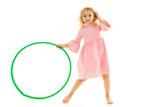 Adorable Blonde Girl Playing or Exercising with Hula Hoop