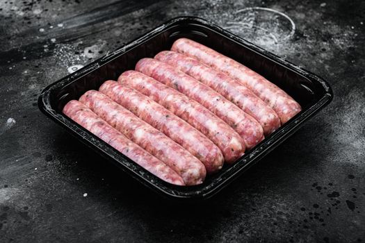 Fresh Polish Sausages pack, on black dark stone table background