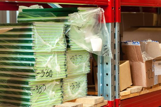 Cardboard sheets pack on a shelf of warehouse