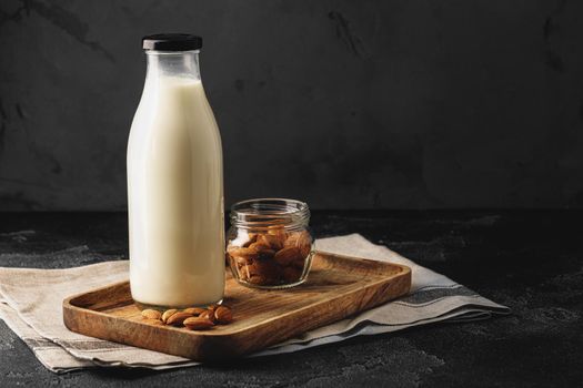 Almond milk with almond nuts in glass