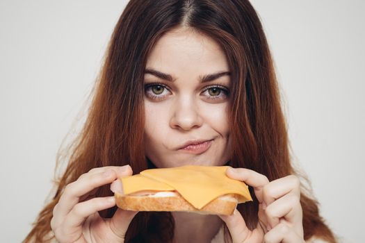 red-haired woman with a sandwich snack close-up