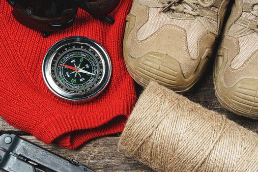 Mountain boots and hiking gear on wooden planks