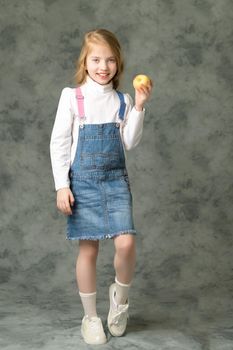Little girl with apple.Studio portrait.