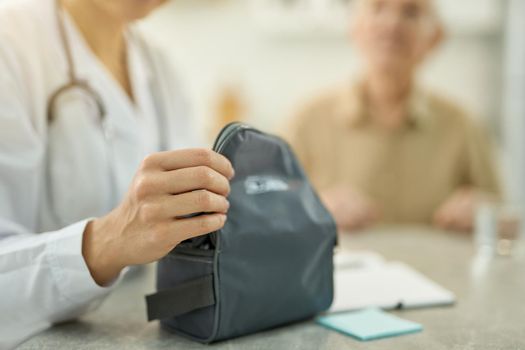 Medicare staff opening a black case with medical device