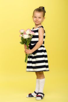 Cute girl in nice dress with bouquet of flowers