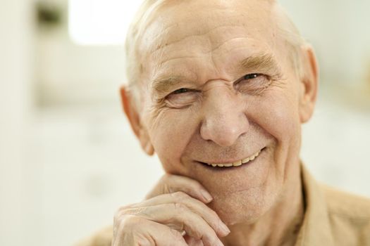 Outgoing grandpa looking optimistic while posing for camera