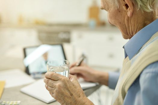 Elderly man following doctor prescription on video-call