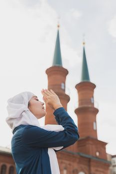 Muslim woman prayer wear hijab fasting pray to allah on mosque background